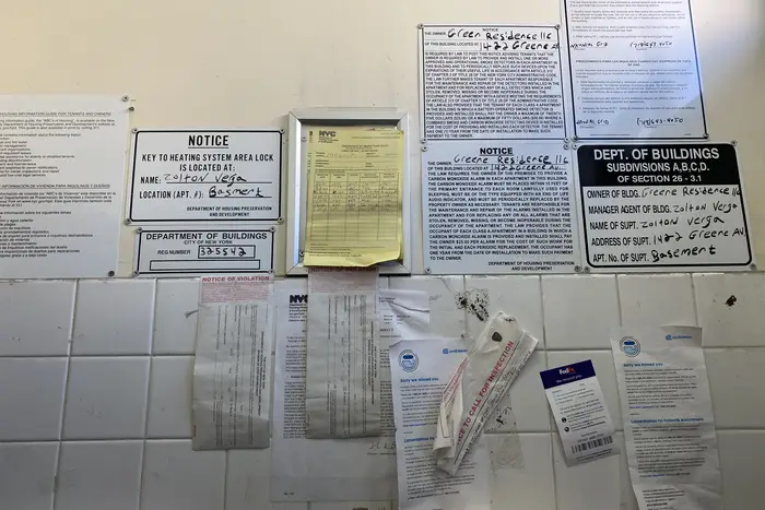 The lobby of 1422 Greene Ave is littered with notices and warnings about utility shutoffs.